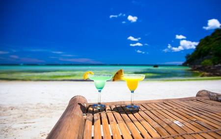 Two tasty alcoholic cocktails on tropical white beachの写真素材