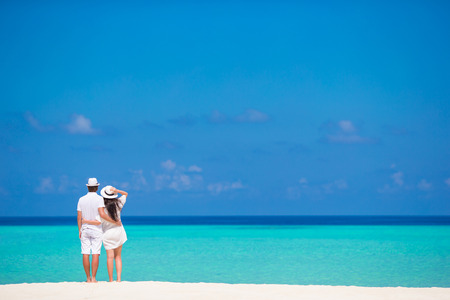 Young happy couple on white beach at summer vacationの写真素材