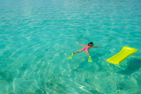 Young girl snorkeling in tropical water on vacationの写真素材