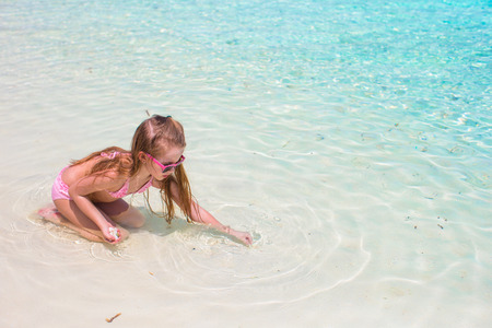 Adorable little girl at beach during summer vacationの写真素材