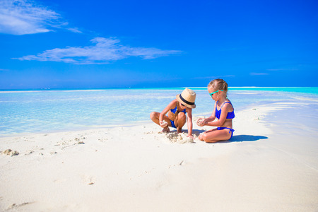 Adorable little girls on beach during summer vacationの写真素材