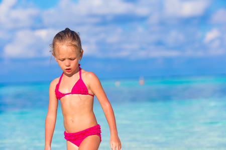 Adorable little girl at beach during summer vacationの写真素材
