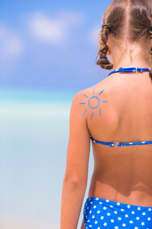 Close up sun painted by sun cream on kid shoulderの写真素材