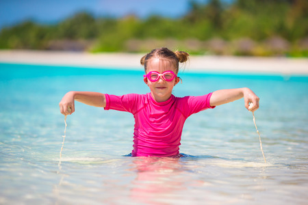 Adorable little girl at beach during summer vacationの写真素材