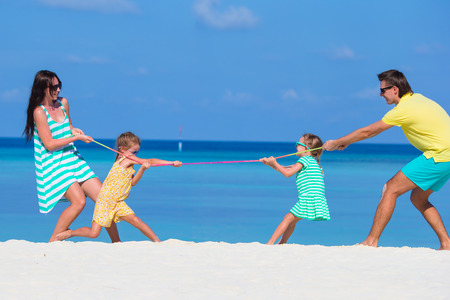 Happy beautiful family on a beach during summer vacationの写真素材