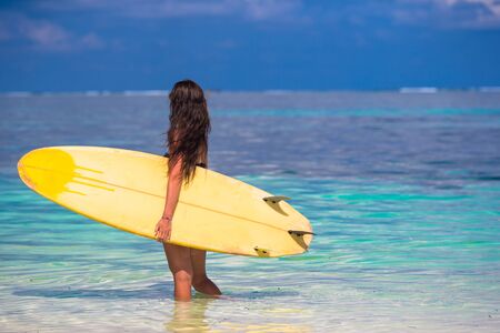 Beautiful surfer woman surfing during summer vacation