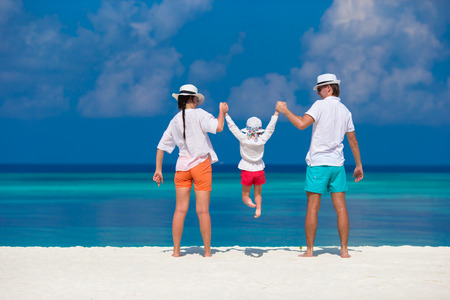 Young family on white beach during summer vacationの写真素材