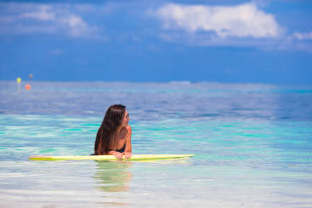 Young surfer woman surfing during beach vacationの写真素材