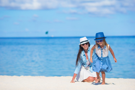 Little girl and young mother during beach vacationの写真素材