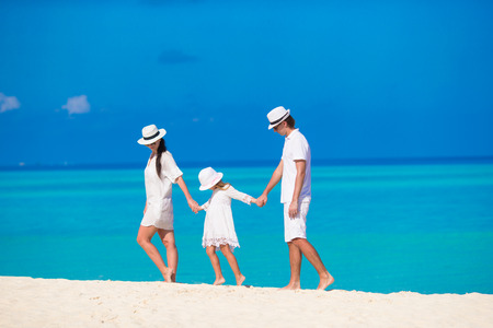 Young parent and little kid on white tropical beachの写真素材