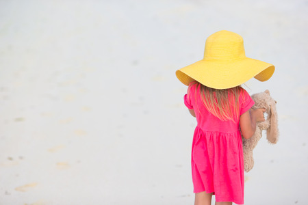 Adorable little girl in hat at beach during summer vacationの写真素材