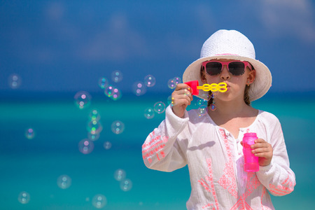 Adorable little girl making soap bubbles during summer vacationの写真素材