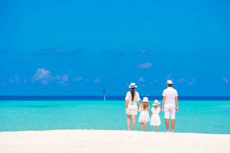 Beautiful tropical beach landscape with family in white enjoying summer vacationの写真素材