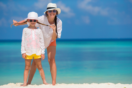 Little girl and young mother during beach vacationの写真素材