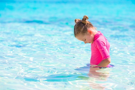 Adorable little girl at beach during summer vacationの写真素材