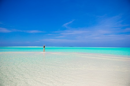 Young girl on tropical white  beachの写真素材