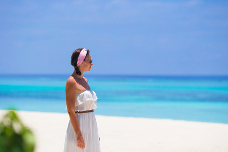 Young happy woman on white sandy beachの写真素材
