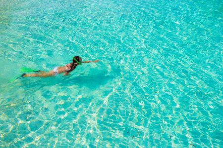 Young girl snorkeling in tropical water on vacationの写真素材