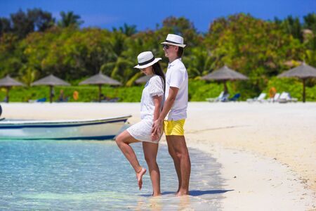 Young happy couple on white beach at summer vacationの写真素材