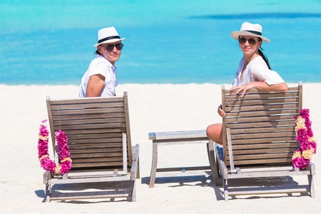 Young happy couple on white beach at summer vacationの写真素材