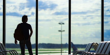 Silhouette of a man waiting to board a flightの写真素材