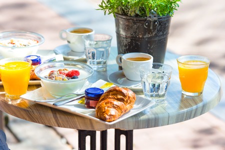 Tasty and delisious breakfast in outdoor cafe at european cityの写真素材