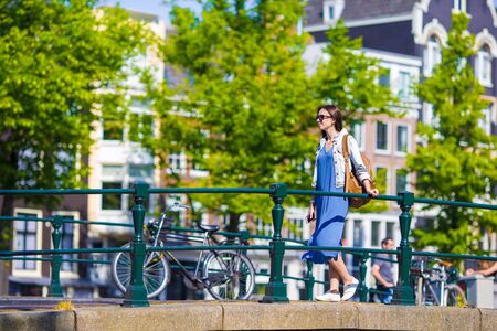 Young beautiful girl walking in european city, Amsterdam, Hollandの写真素材