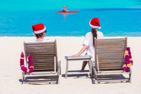 couple in Santa hats relaxing on tropical beach during Christmas vacationの写真素材