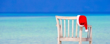 Red santa hat on chair longue at tropical caribbean beachの写真素材