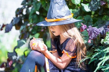 Happy girl in halloween costume with jack pumpkin.Trick or treat