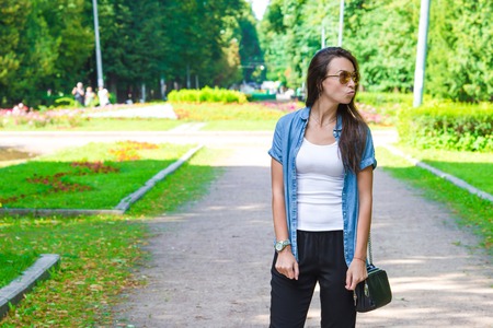 Young girl with a glass of coffee for a walk on the streetの写真素材
