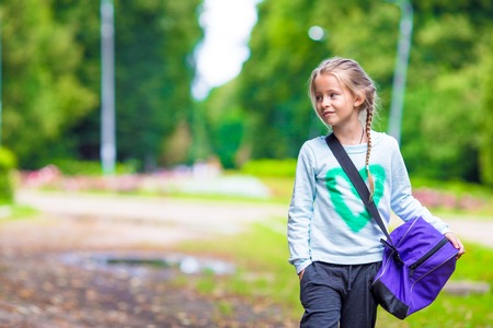 Little girl goes to the gym with her sports bagの写真素材