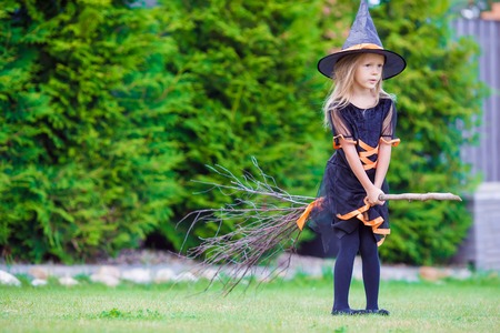 Happy girl in halloween costume with jack pumpkin.Trick or treat
