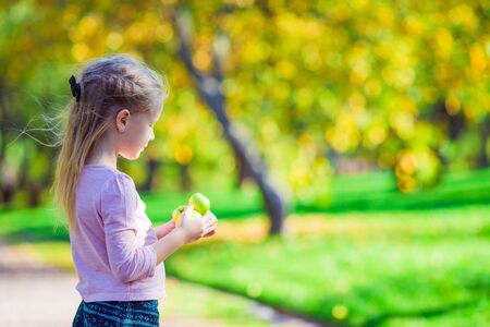 Adorable little girl at beautiful autumn day outdoorsの写真素材
