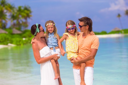 Beautiful tropical beach landscape with family in white enjoying summer vacationの写真素材