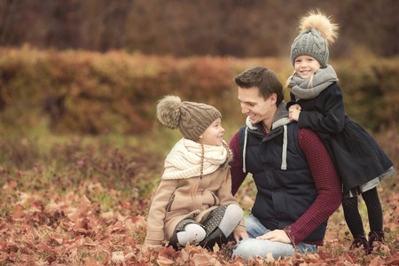 Cute little girls with happy dad enjoy autumn vacationの写真素材