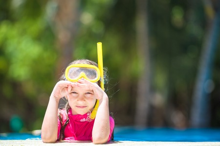 Happy beautiful girl having fun in outdoor swimming poolの写真素材