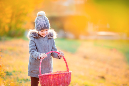 Adorable little girl at beautiful autumn day outdoorsの写真素材