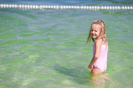 Cute little girl at beach during summer vacationの写真素材