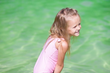 Adorable little girl at tropical white beachの写真素材