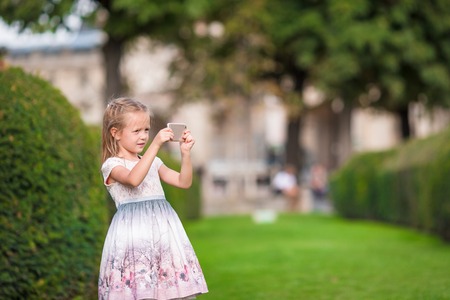 Adorable little girl in Paris background the Eiffel tower in Franceの写真素材