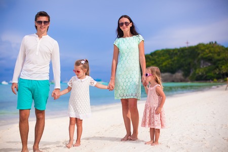 Happy beautiful family on a beach during summer vacationの写真素材