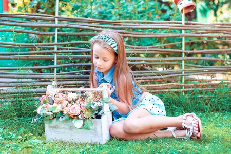 Adorable little girl outdoor in the yardの写真素材