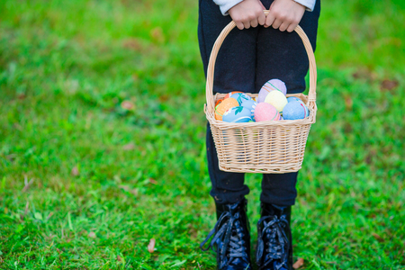 Child holding a basket with easter eggsの写真素材