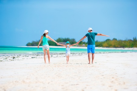 Happy beautiful family on a beach during summer vacationの写真素材