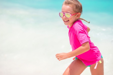 Adorable little girl at beach during summer vacationの写真素材