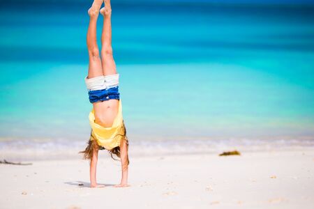 Adorable little girl at beach during summer vacation