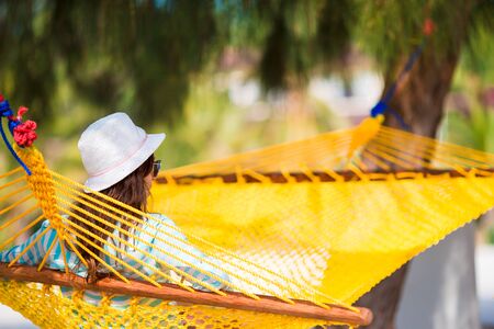 Woman relaxing on hammock on tropical vacationの写真素材