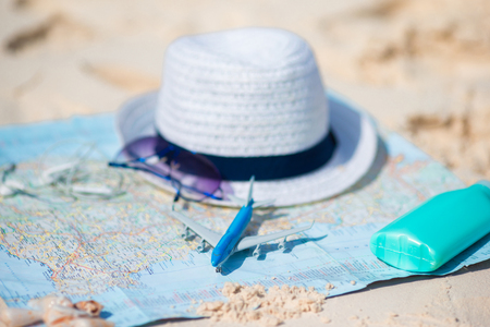 Closeup of passports, toy airplane, sunglasses on the mapの写真素材