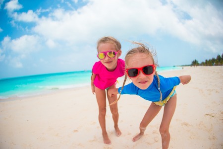 Adorable little sisters at beach during summer vacationの写真素材
